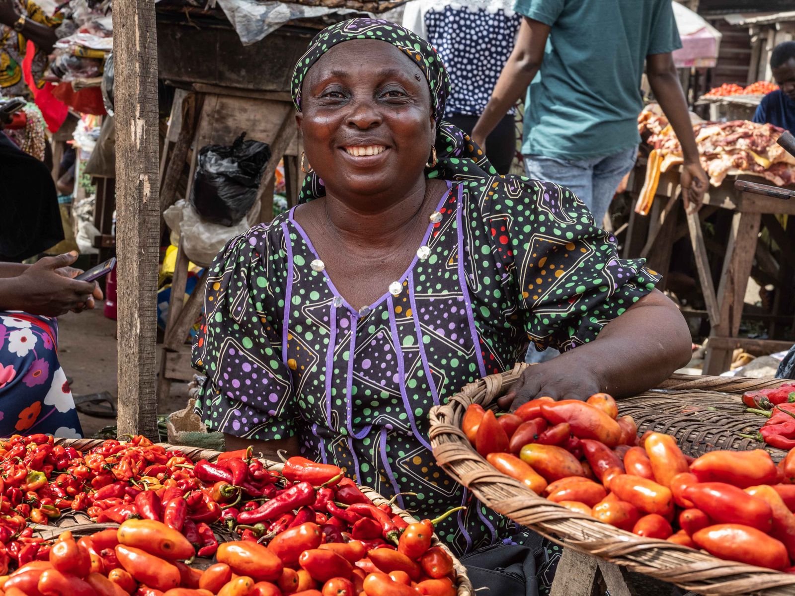A vendor at her pepper and tomato stall in a Nigerian market